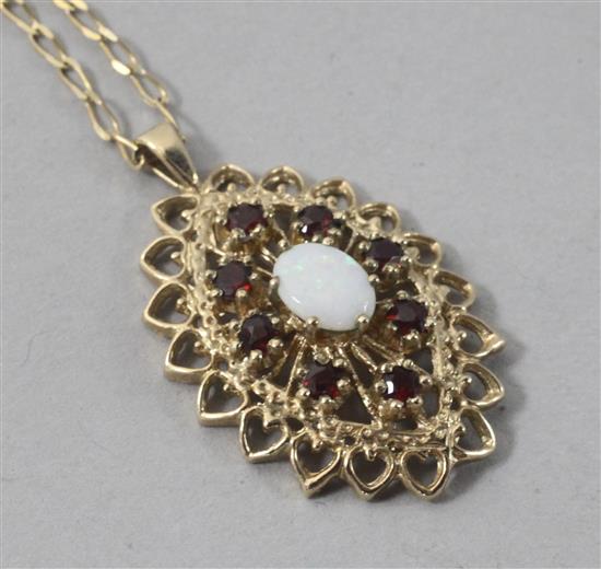 A modern 9ct gold, white opal and garnet pendant, on a 9ct gold chain, pendant 27mm.